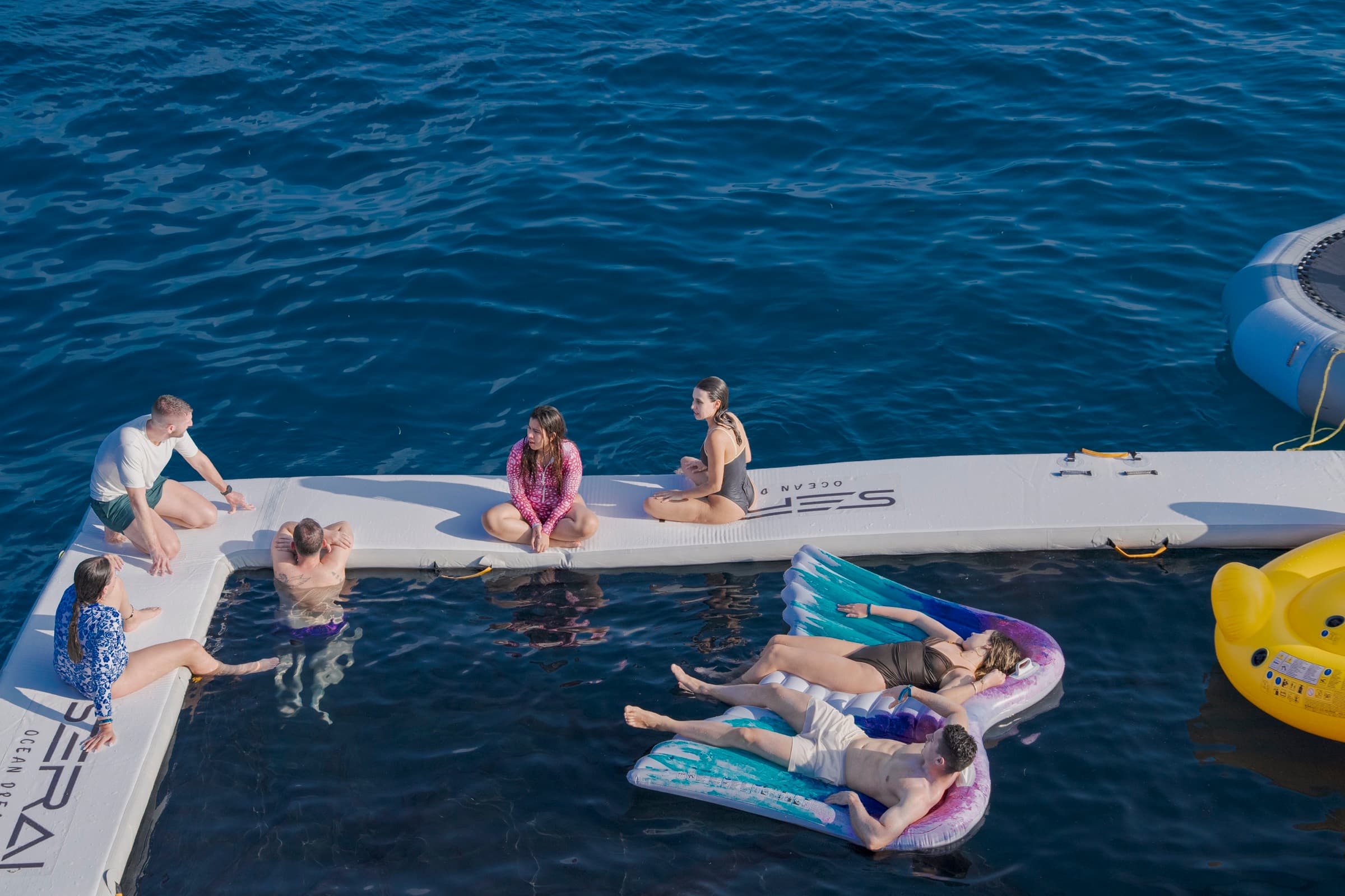 Guests enjoying SERAI swim platform and water activities